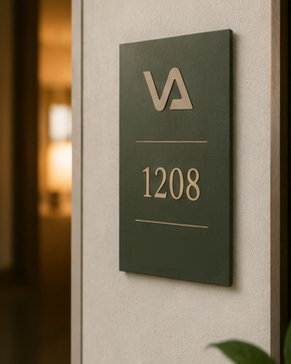 VAVABUY guest-room signage — gold VA monogram on green plaque, room 1208